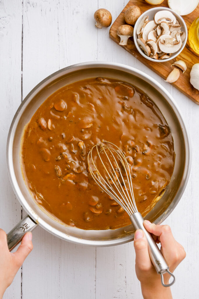 Making salisbury steak mushroom gravy in a skillet