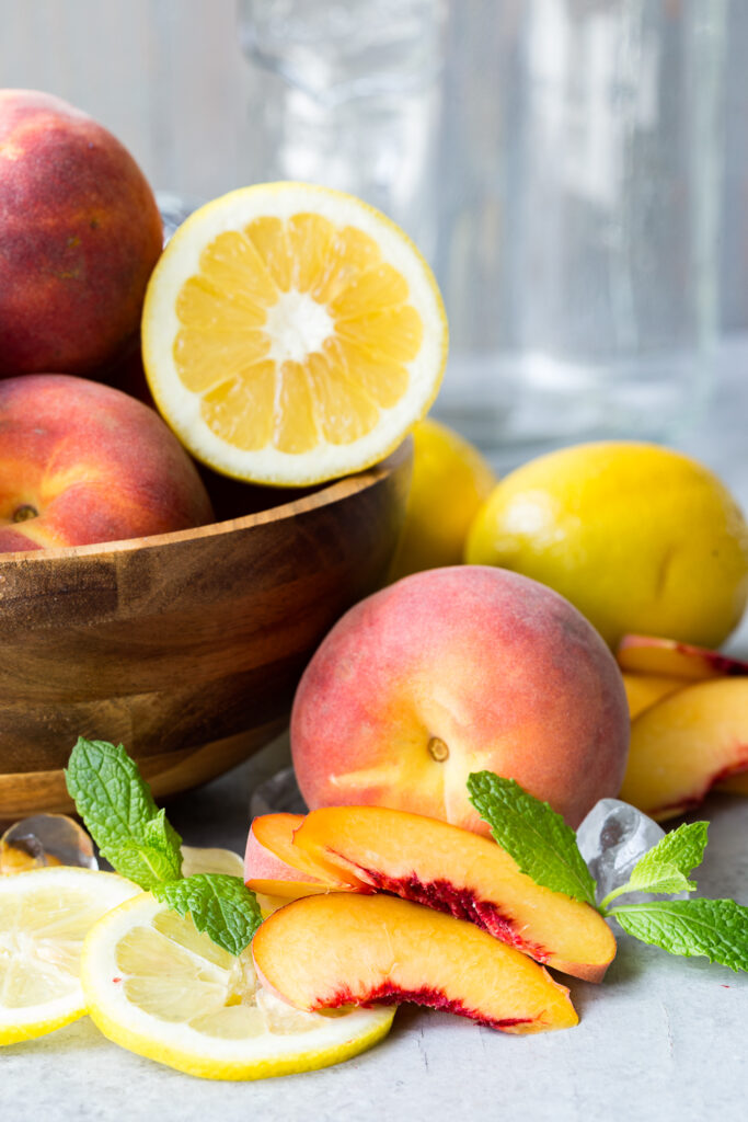 The ingredients for a fresh peach lemonade, the perfect summer drink.