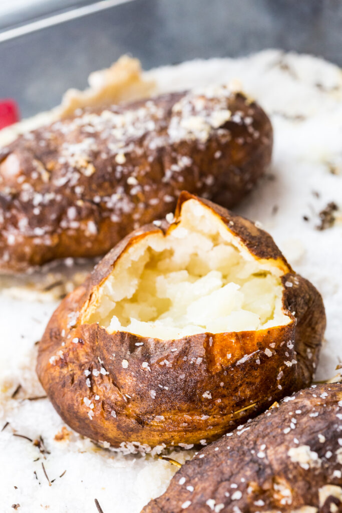 Salt baked potatoes, a deliciously fluffy and light baked potato, cooked in a bed of salt with garlic and rosemary. 