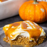 a delicious pumpkin poke cake, loaded with creamy frosting and caramel sauce