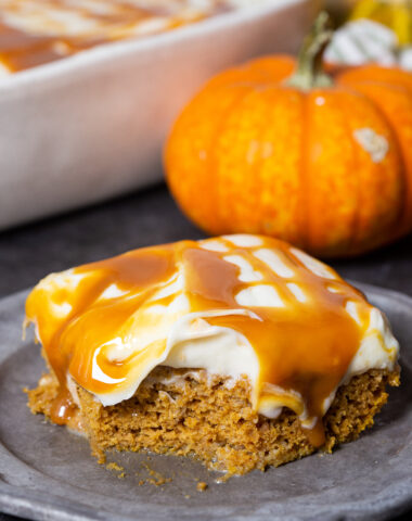 a delicious pumpkin poke cake, loaded with creamy frosting and caramel sauce