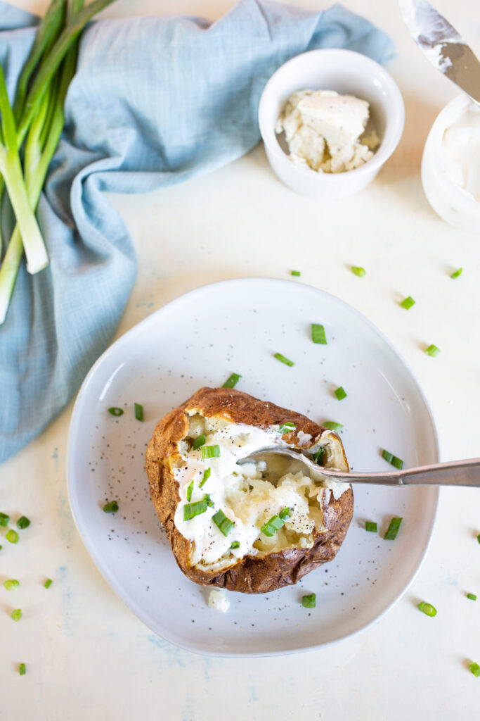 An air fryer baked potato with toppings