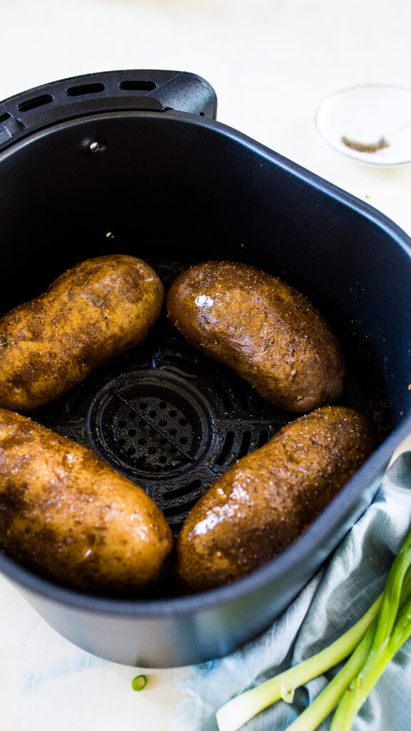 Easy air fryer "baked" potatoes, making crispy skin and fluffy interior baked potatoes in the air fryer. 