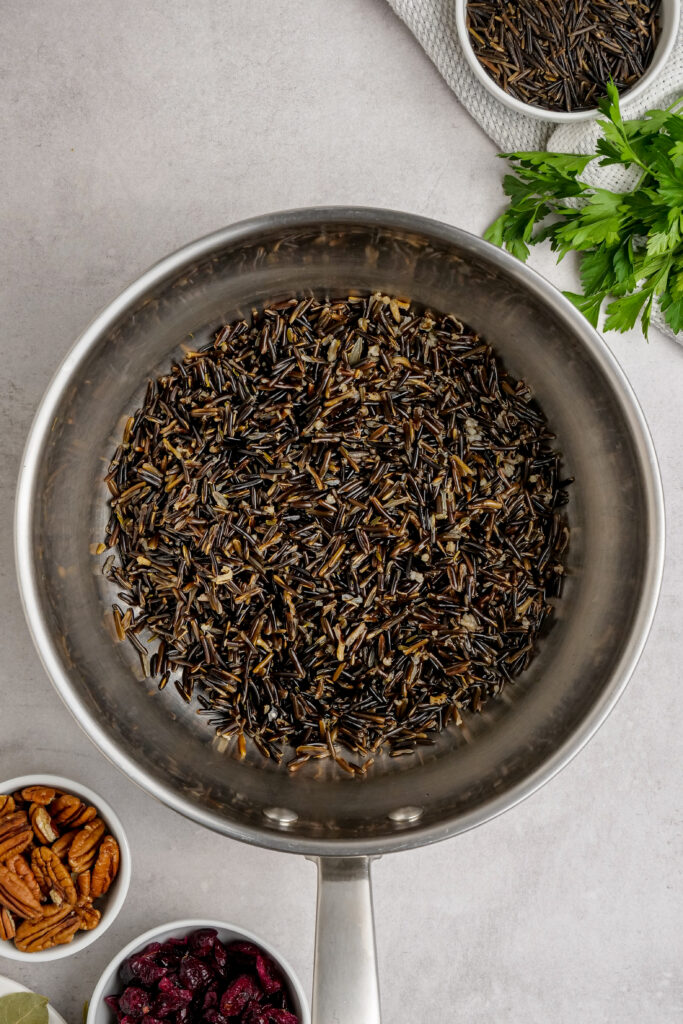 Wild rice in a sauce pan after being rinsed