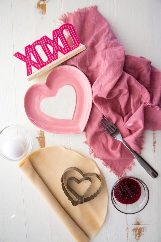 What you need to make homemade pop hearts, only 3 ingredients. The most fun, 3 ingredients, "Pop Hearts", or in other words, buttery, flakey, raspberry homemade pop tarts. Indulge in these fresh, homemade, but oh so simple, raspberry filled pop tarts! Crispy and flaky on the outside, warm and gooey and tart raspberry on the inside, each bite is bursting with flavor, and they take only minutes to make