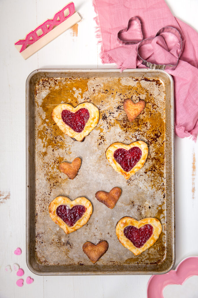 Already baked Buttery, flakey, raspberry homemade pop tarts. On a baking sheet