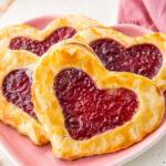 Pop hearts, homemade pop tarts, flakey pie crust stuffed with raspberry jam and baked to golden perfection.