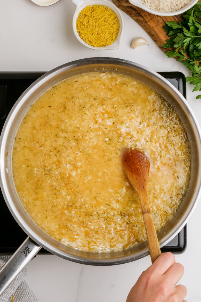 Herbed Rice Pilaf: Adding herbs and liquid to your base for herbed rice pilaf, and letting that cook. 