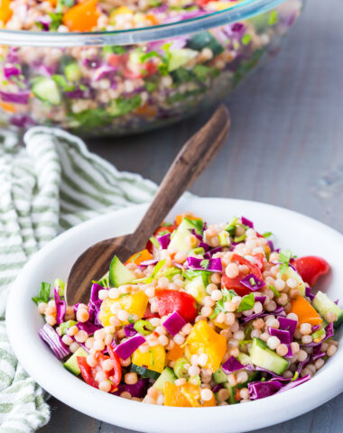 A bowl of couscous salad with tons of fresh herbs and veggies