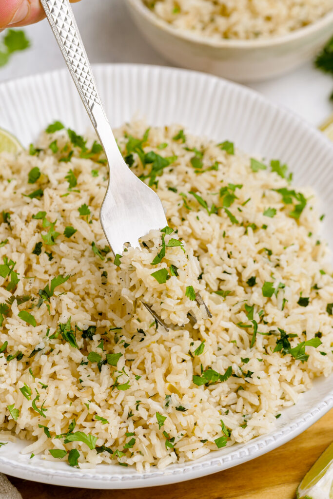 Cilantro lime rice is served properly with fresh cilantro, fresh lime juice.