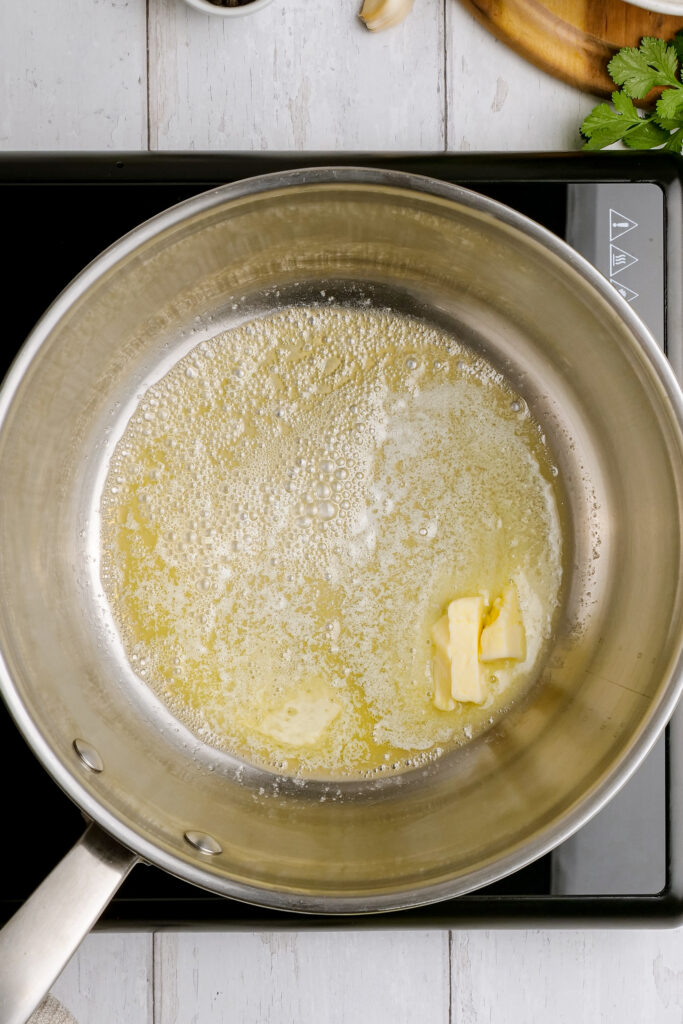 Melting butter in a saucepan to make cilantro lime rice