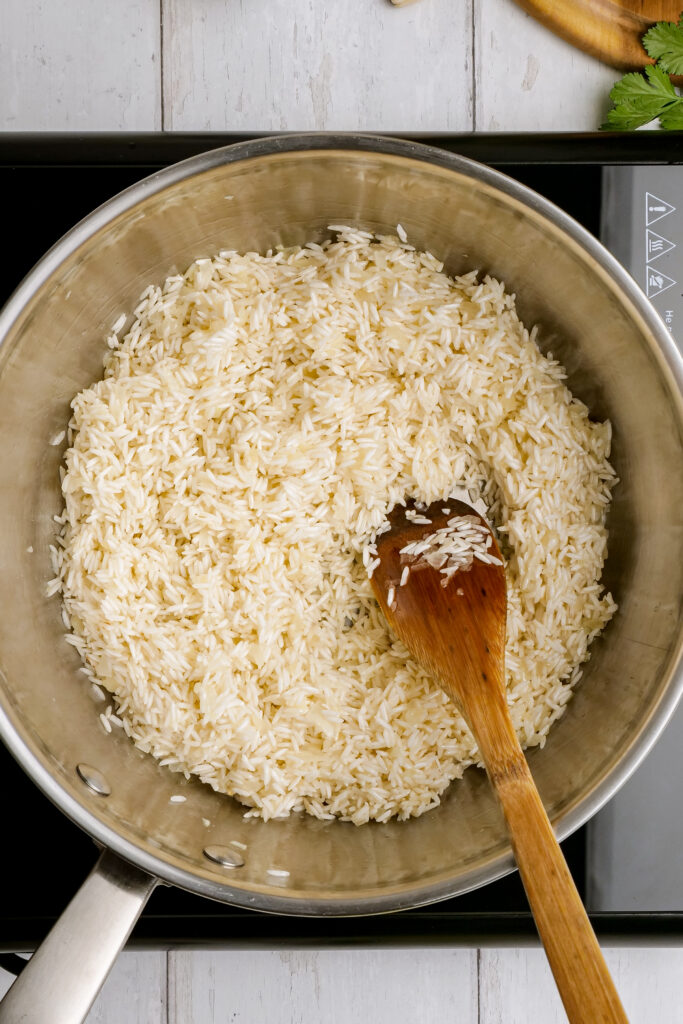Adding rice to your melted butter with the cilantro lime rice