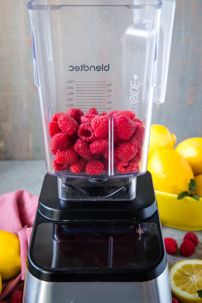 A blender of raspberries for raspberry lemonade