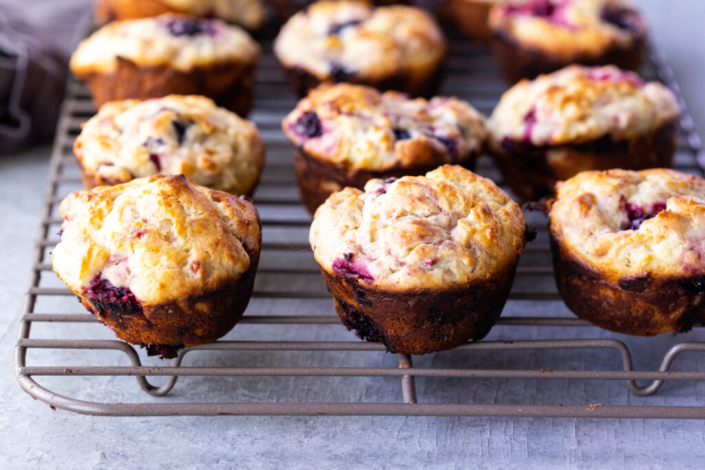 Letting triple berry muffins cool on a rack