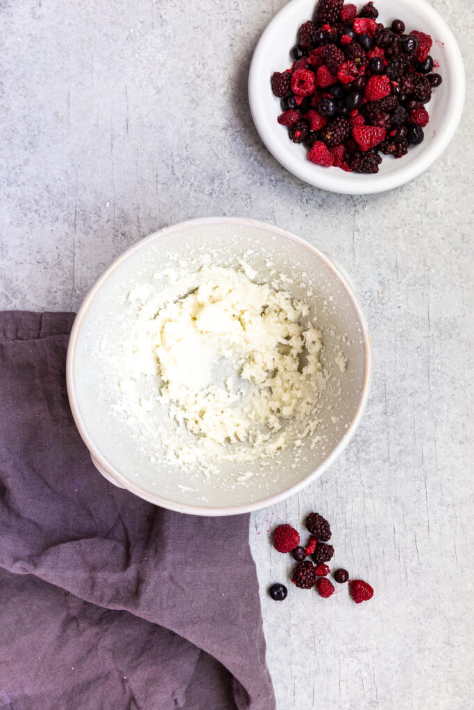 creaming butter and sugar together for triple berry muffins