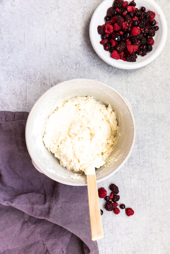 Folding in the dry ingredients for triple berry muffins