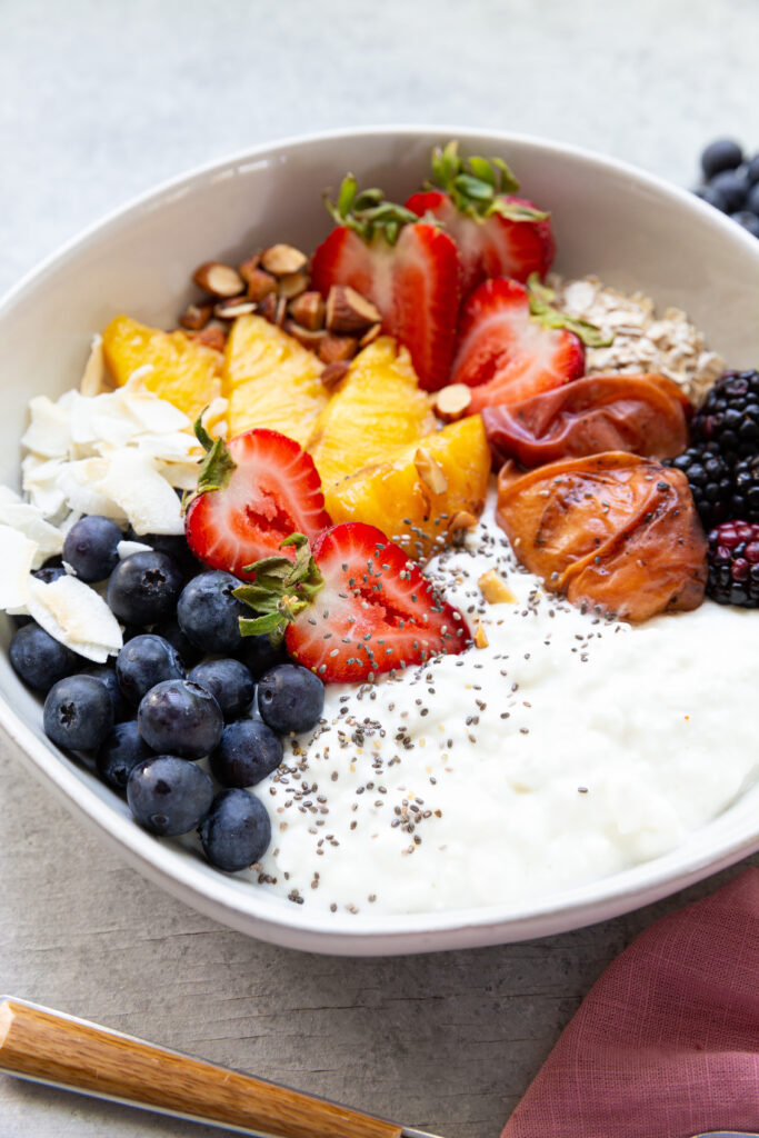 Cottage Cheese Breakfast Bowl, topped with fresh fruit and grilled fruit. 