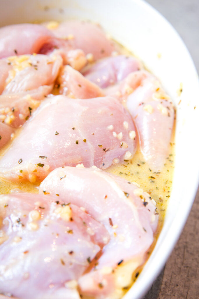 Marinating chicken thighs to make grilled chicken.