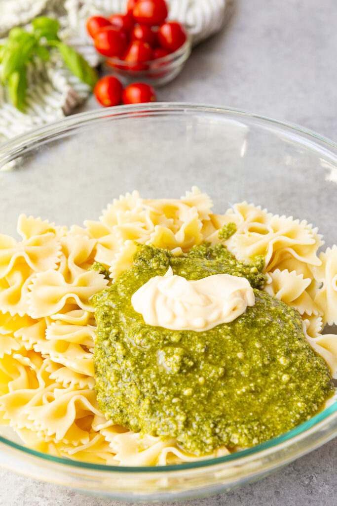 Mixing together the sauce for pesto pasta salad