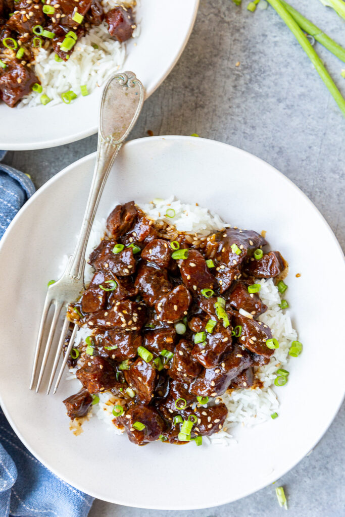 Teriyaki Beef made in the slow cooker and topped with green onion and sesame seeds