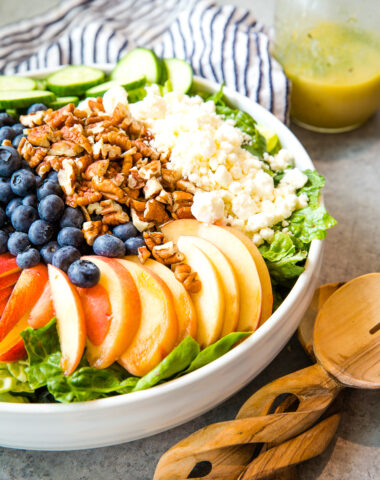 Peach berry summer salad in a white bowl