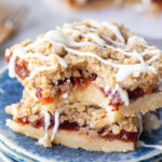 Cherry pie bars, made with sour cherries, a shortbread like crust, and an oatmeal crumble with powdered sugar glaze. Easy, delicious, and so fun.