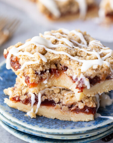 Cherry pie bars, made with sour cherries, a shortbread like crust, and an oatmeal crumble with powdered sugar glaze. Easy, delicious, and so fun.