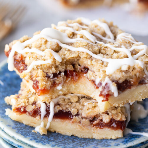 Cherry pie bars, made with sour cherries, a shortbread like crust, and an oatmeal crumble with powdered sugar glaze. Easy, delicious, and so fun.