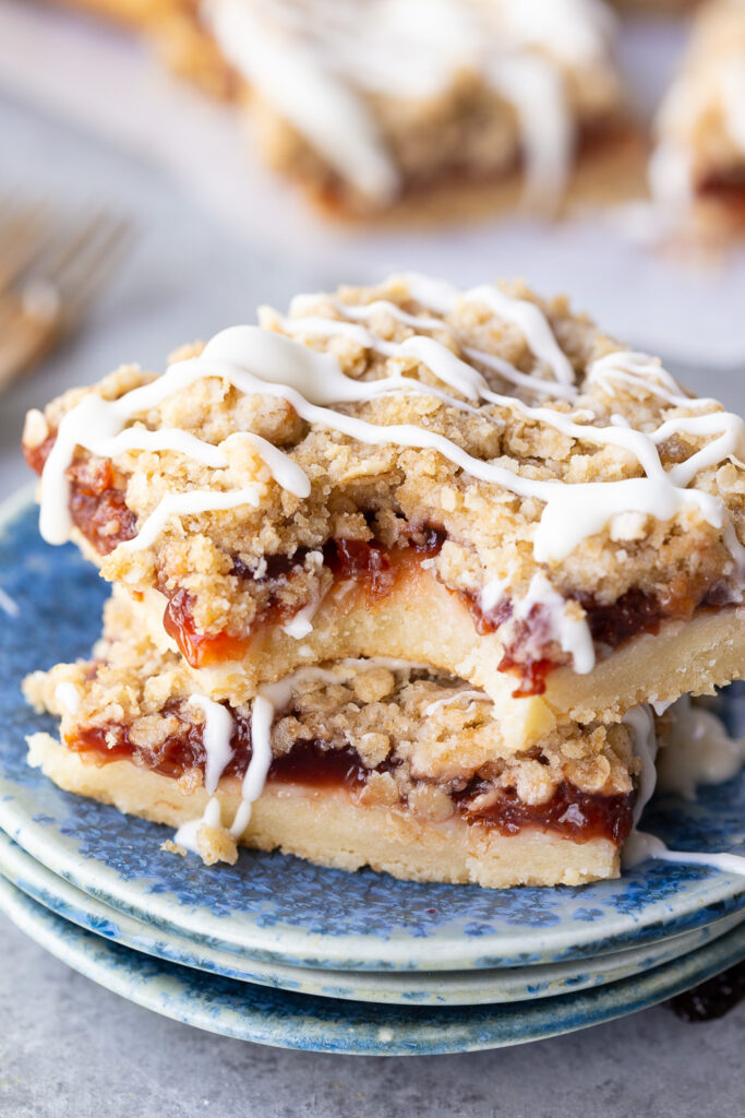 Cherry pie bars, made with sour cherries, a shortbread like crust, and an oatmeal crumble with powdered sugar glaze. Easy, delicious, and so fun.