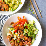 Salmon Rice Bowls with honey sriracha salmon bites, pickled veggies, creamy avocado, green onion and sesame seasoning.