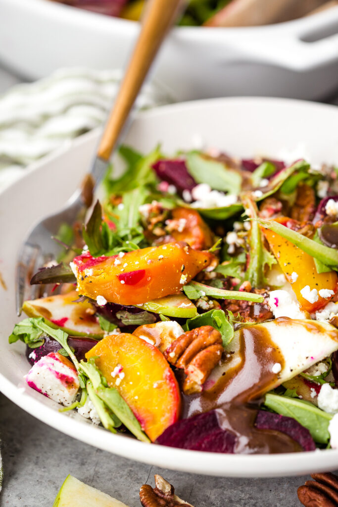 A cozy fall beet salad with mixed greens, goat cheese, two kinds of beets, and toasted pecans. 