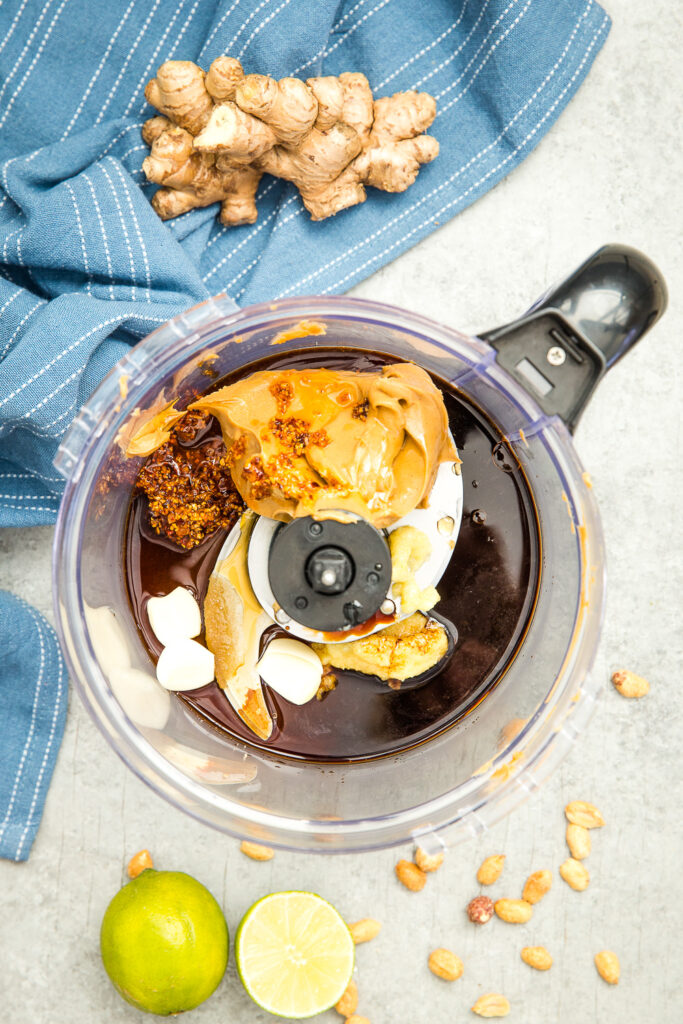 Ingredients for peanut sauce in a food processor