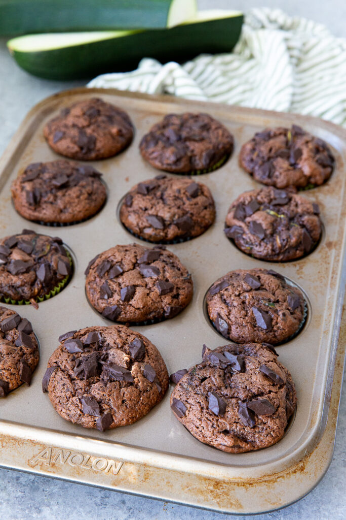 A muffin tin full of chocolate chunk zucchini muffins