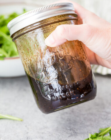 Mixing up the balsamic vinaigrette, shaking it to combine.