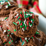 The perfect chocolate christmas cookie, soft and chewy, loaded with chocolate flavor, and topped with drizzled peppermint chocolate and sprinkles.