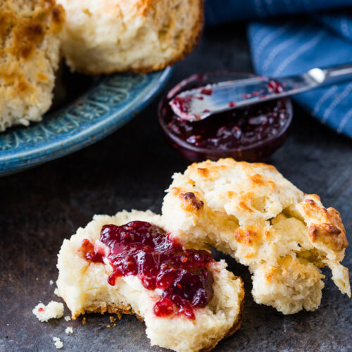 Flaky buttermilk biscuits cooked in a cast iron pan.