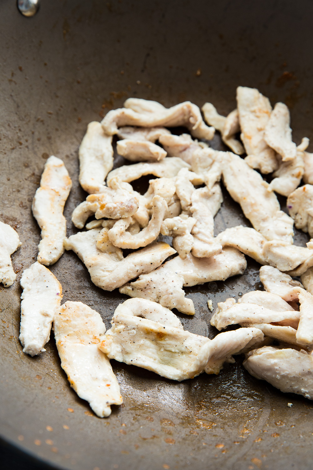 Stir frying the chicken for easy chicken ramen stir fry