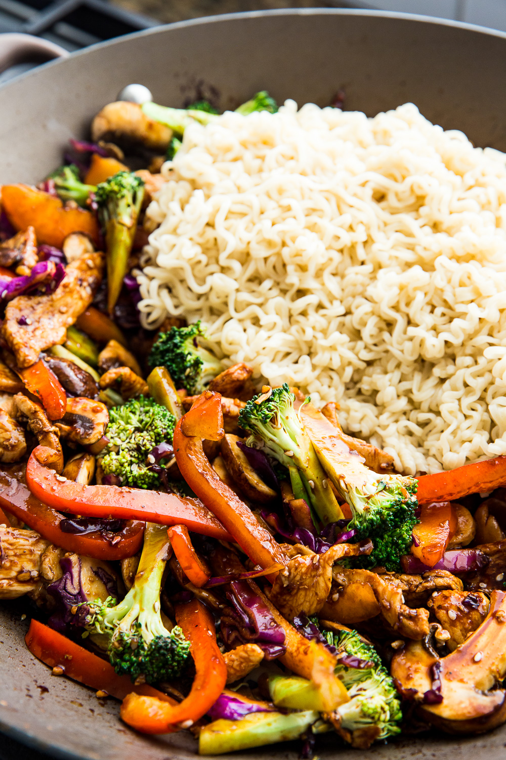 Combining all the ingredients to make chicken ramen stir fry