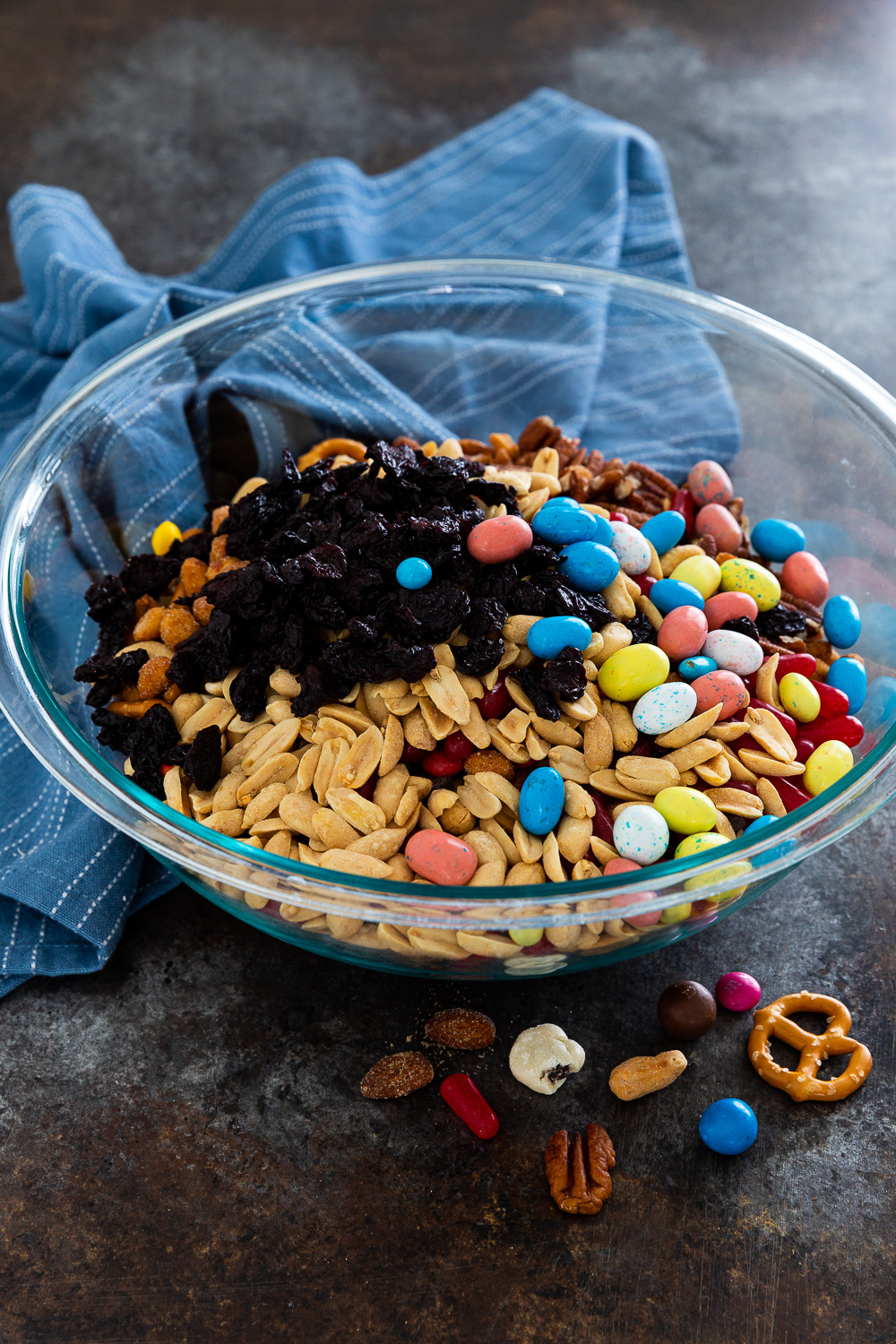 A bowl full of ingredients for homemade trail mix. 