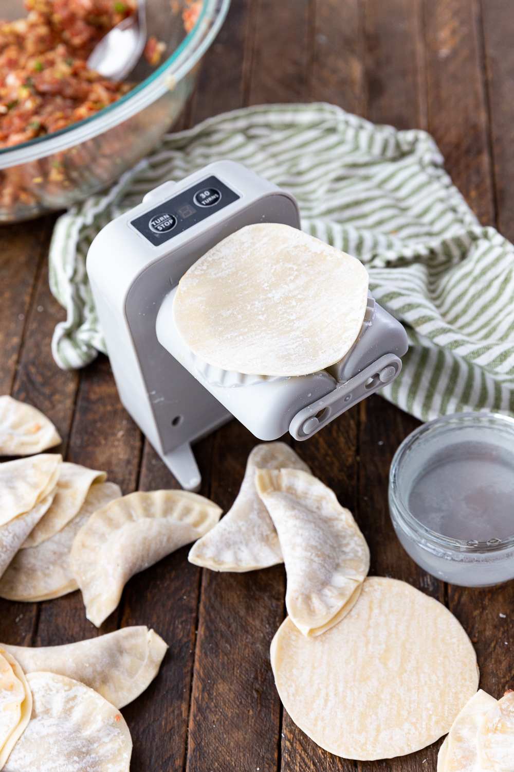 Making pork dumplings with this electric dumpling maker. 