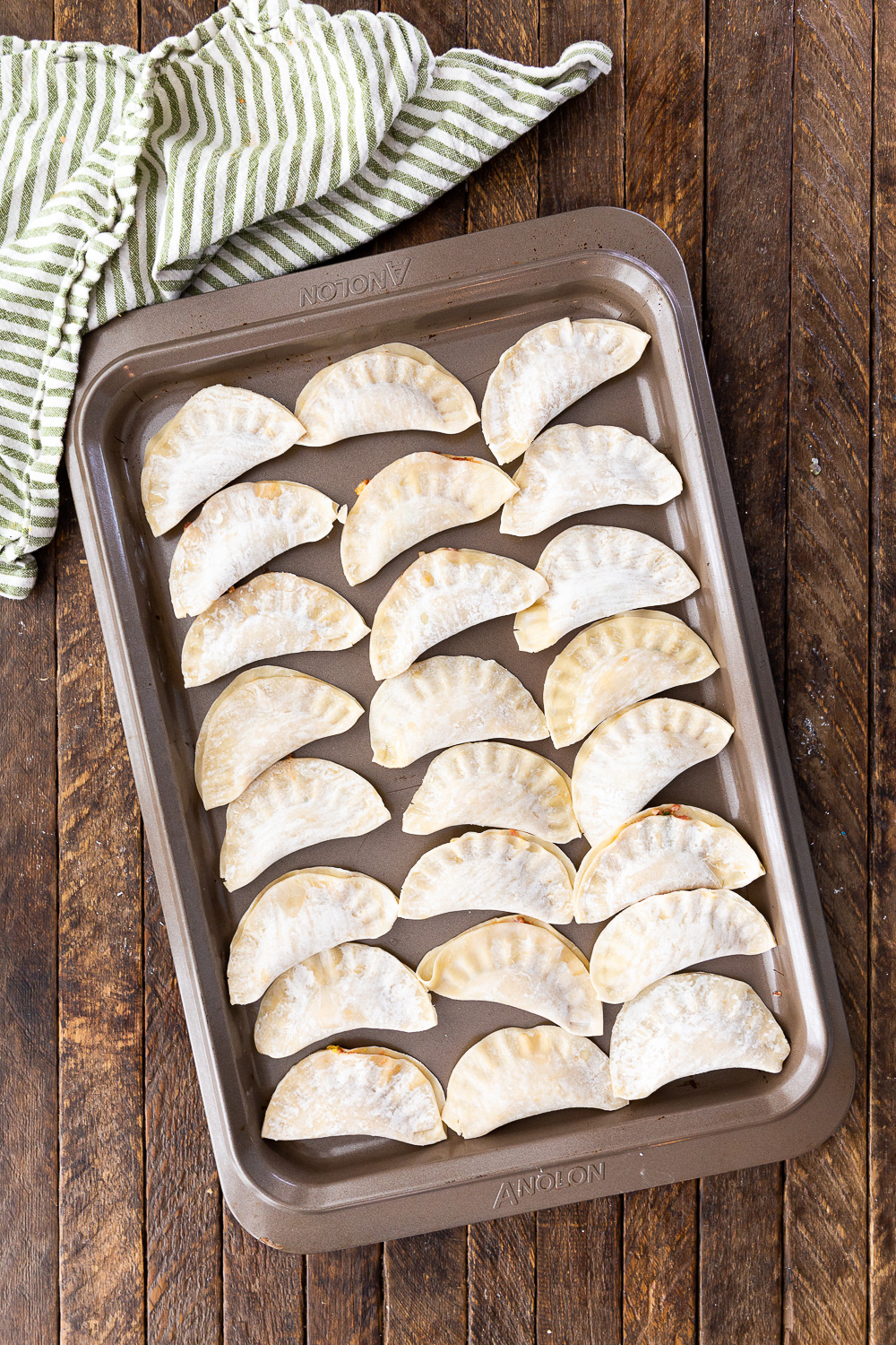 A pan of frozen dumplings, pork dumplings prepped and frozen for future use. 