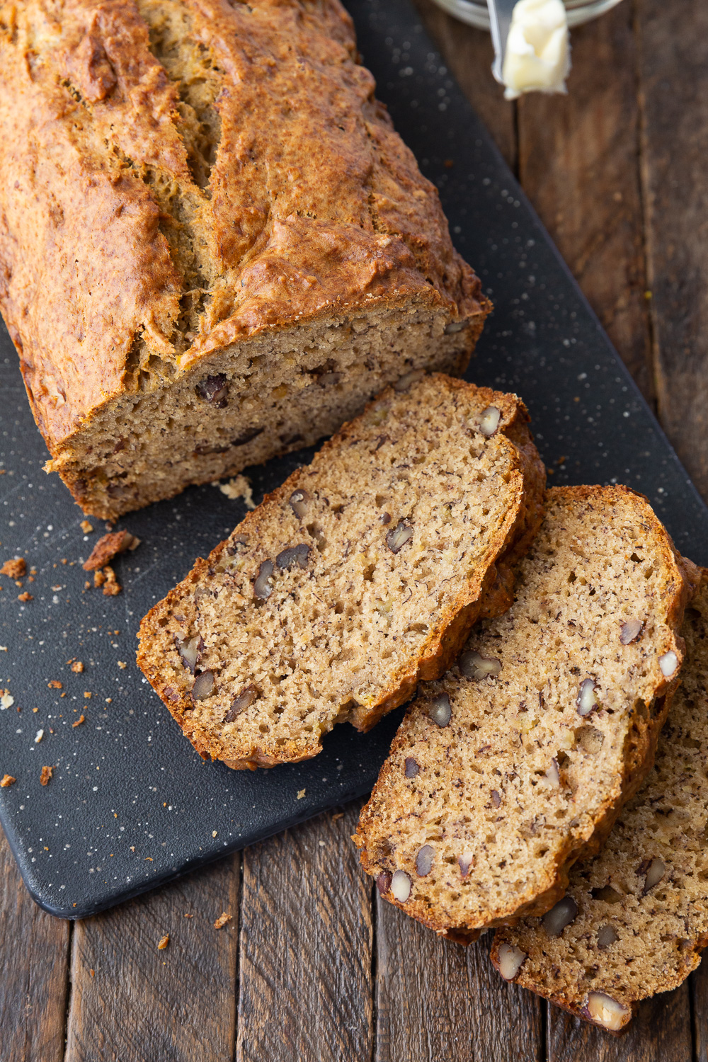 A loaf of browned butter banana bread with a few slices 