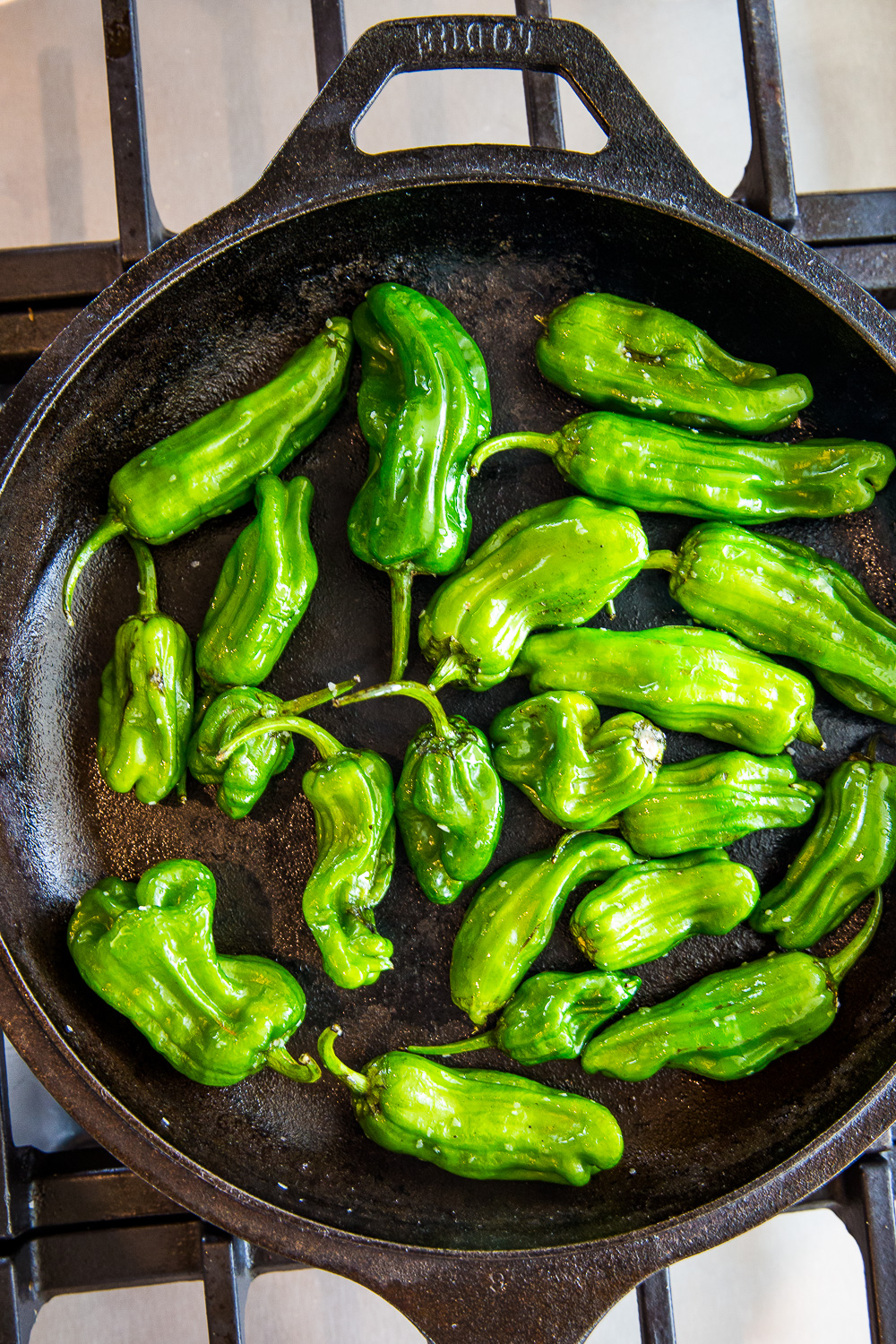 Shishito peppers in a cast iron skillet