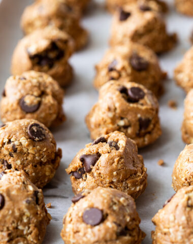 Chocolate Peanut Butter Protein Balls, a delicious snack ball made with oats, peanut butter, honey, vanilla, salt, and chocolate chips, and refrigerated for consumption.
