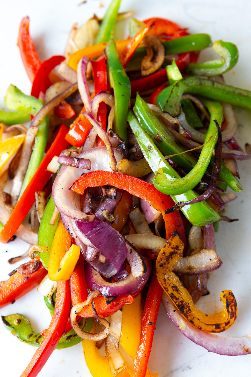 Vegetables cooked on a griddle for chicken fajitas 