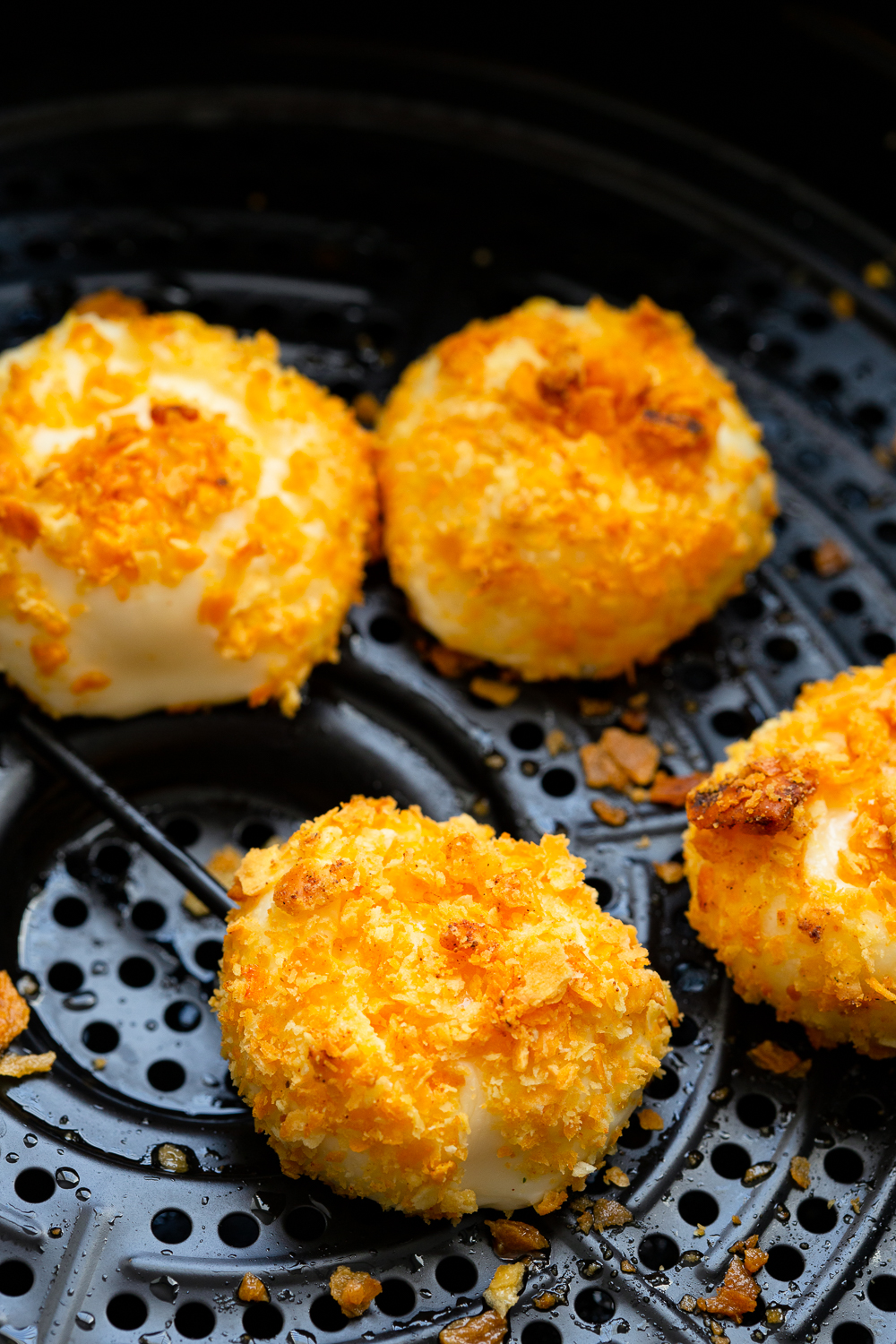 Cooking cheese bites in an air fryer. 