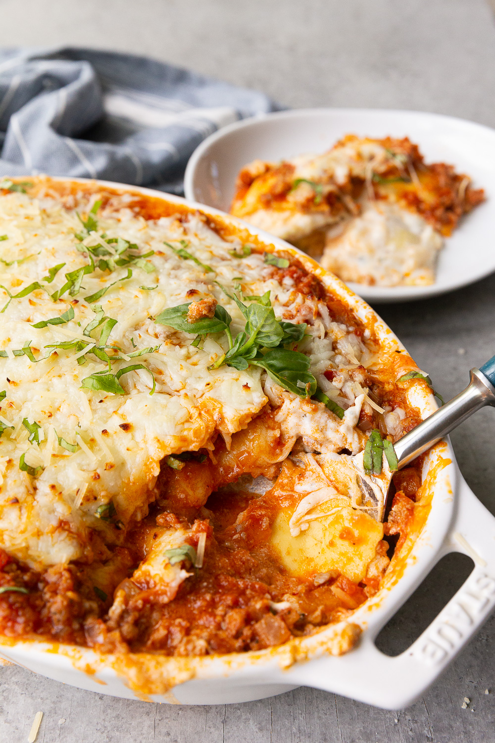 Ravioli lasagna, a lazy lasagna made up of layers of cheese raviolo, meat sauce, ricotta, and mozzarella cheese. 