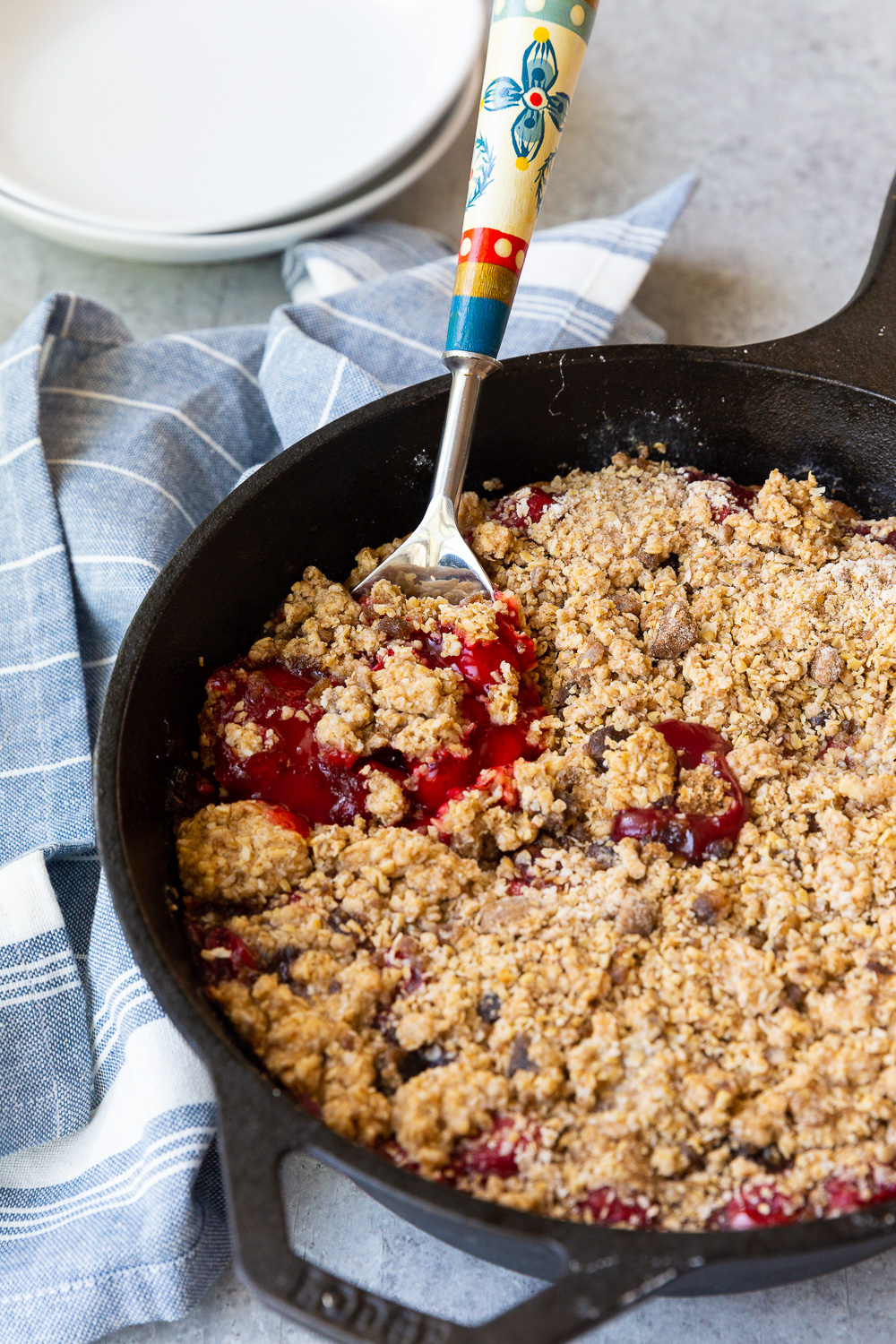 Cooked cherry cobbler, made in a cast iron skillet or dutch oven. 