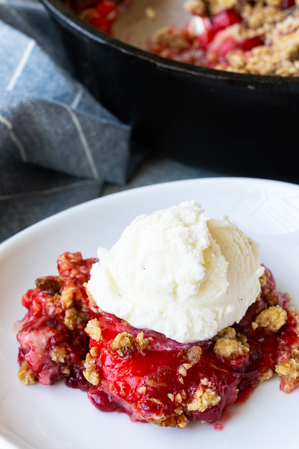 Easy cherry cobbler with an oatmeal crumble, and topped with ice cream.