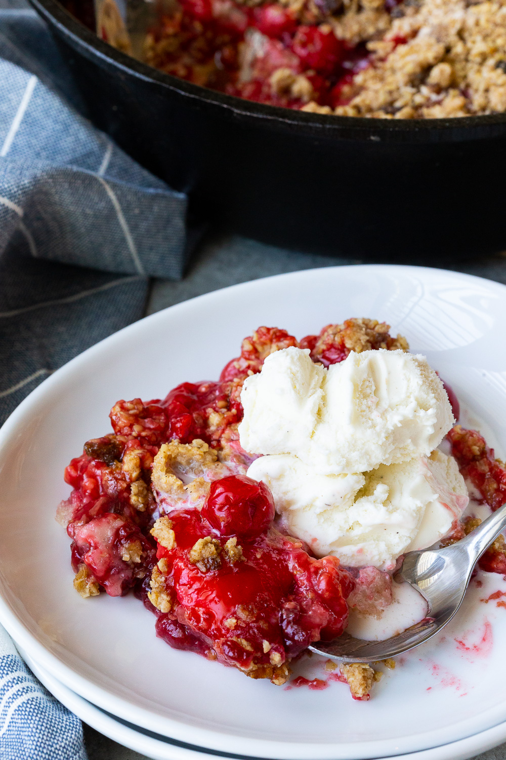 A delicious cherry cobbler, with oatmeal crumble on top and vanilla ice cream. 